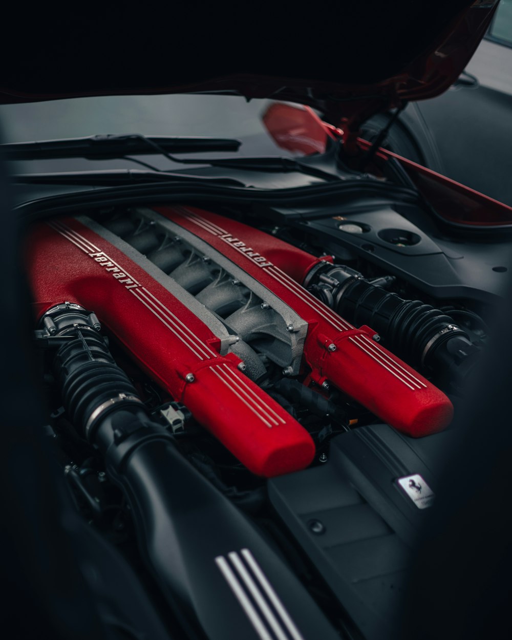 the engine compartment of a car with a red engine cover