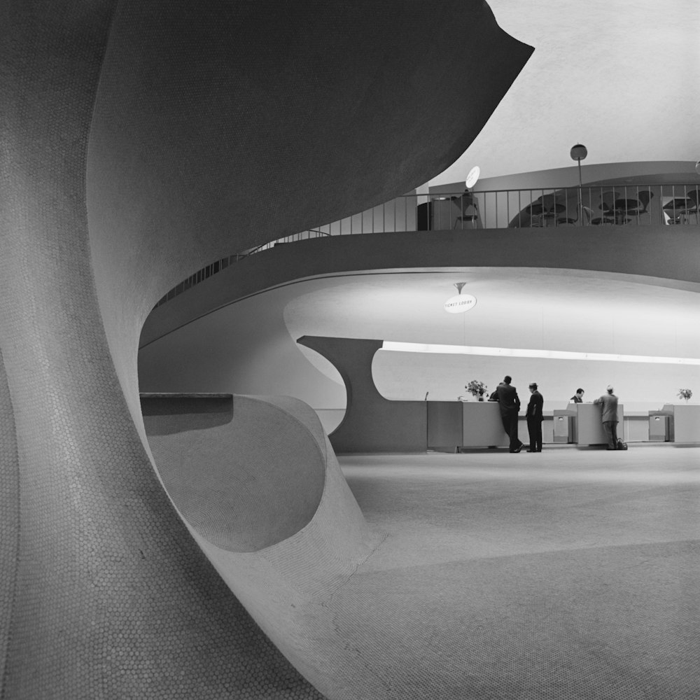 a black and white photo of people in a building