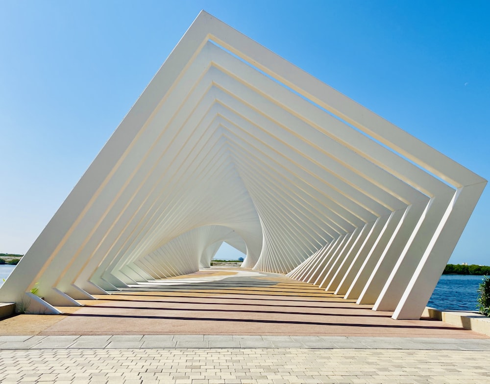 a large white structure sitting next to a body of water