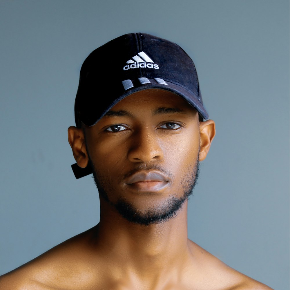 a shirtless man with a hat on his head