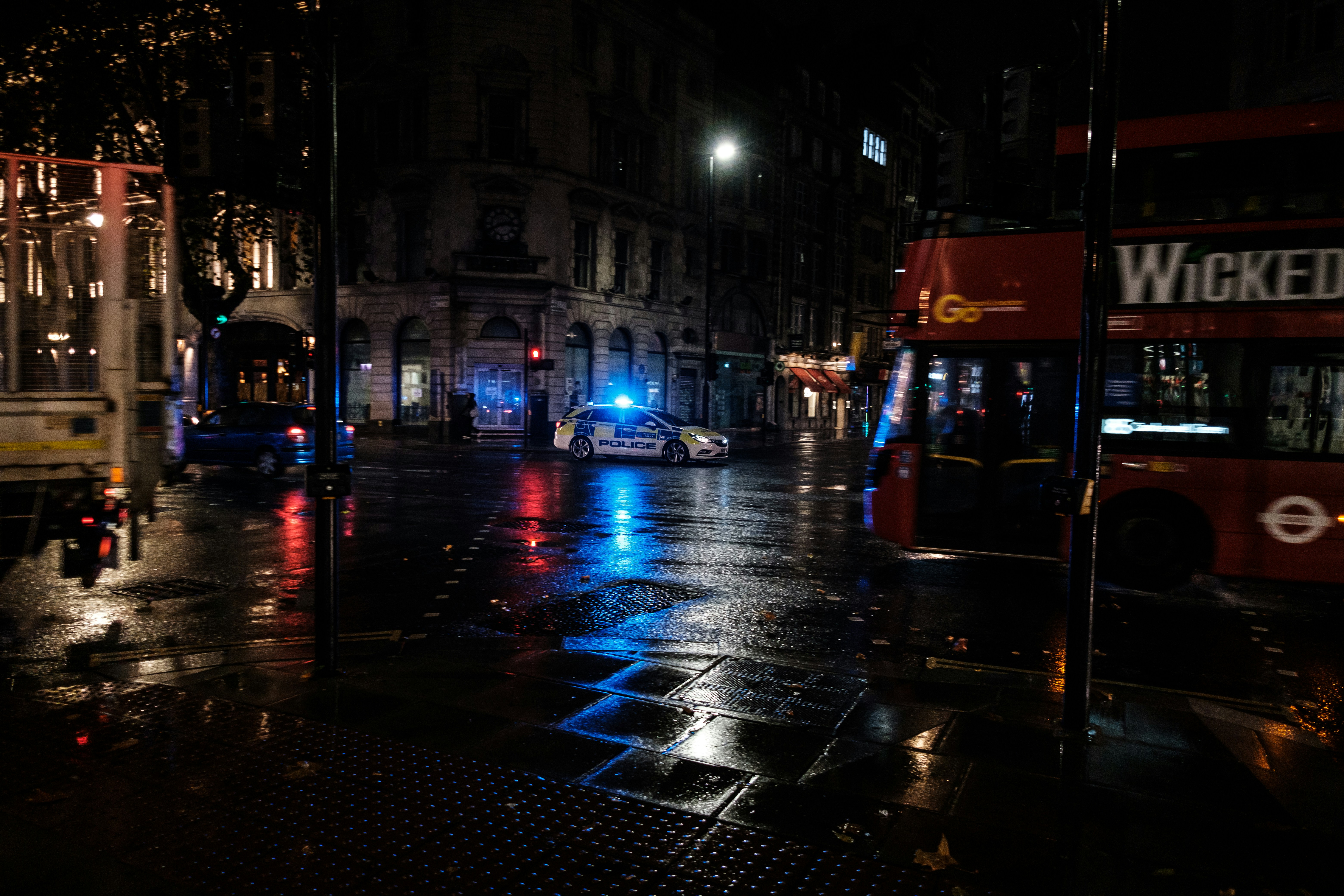 A city street at night with a double decker bus photo – Free City Image ...