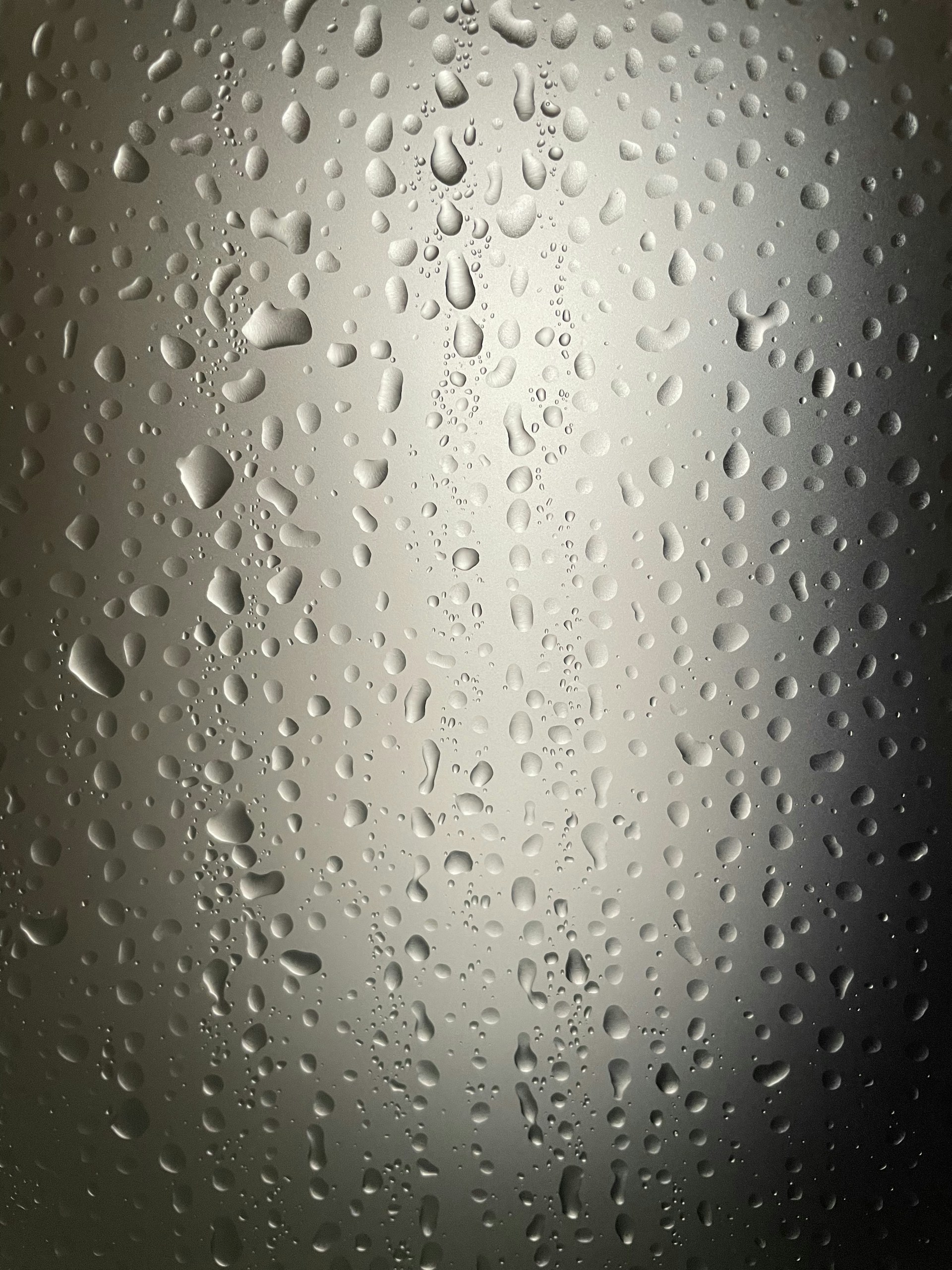 water drops on a glass surface with a black background