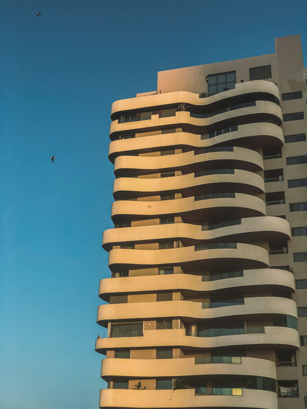 a tall building with balconies on top of it