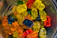 Close-up of colorful gummy worms twisting around each other on a bright background.