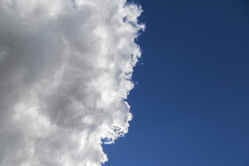 a plane flying in the sky with a lot of clouds