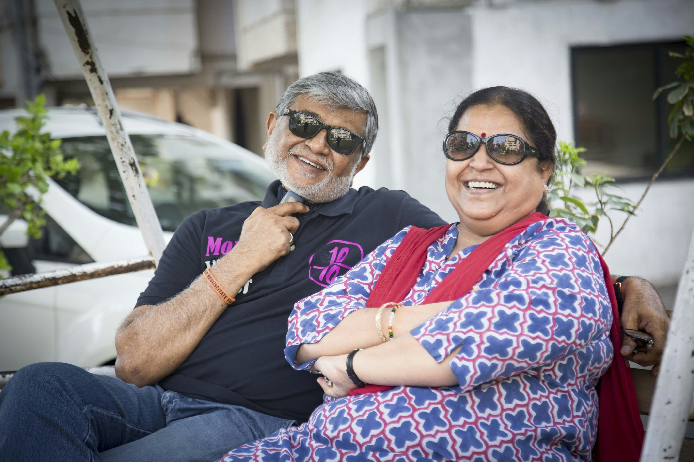 Deepa and Kiran - happy Indian couple smiling in outdoor setting with soft natural lighting
