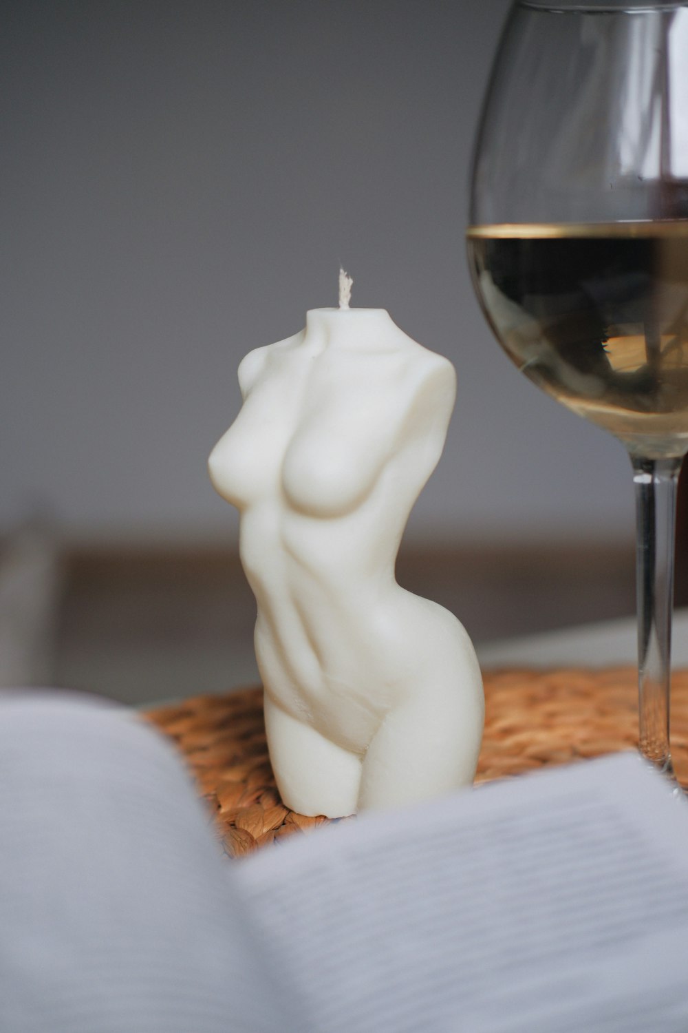 a candle that is next to a glass of wine