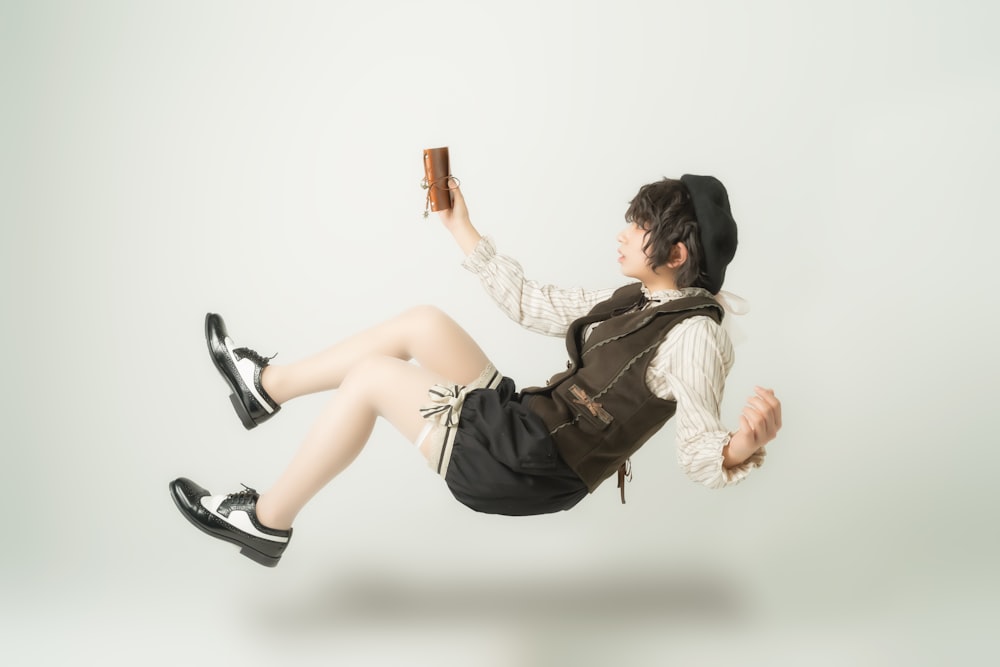 a woman flying through the air while holding a book