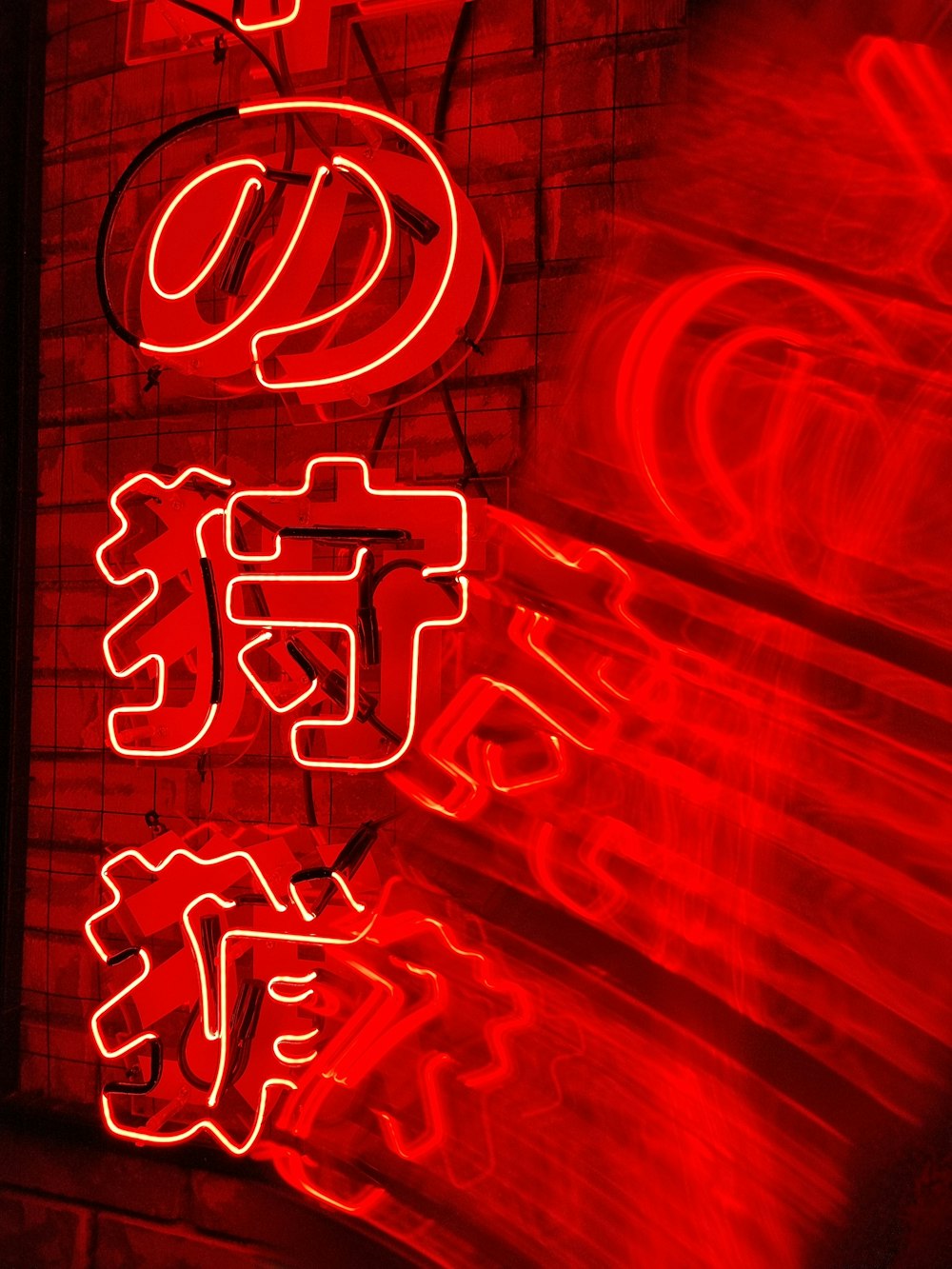 a red neon sign with chinese writing on it