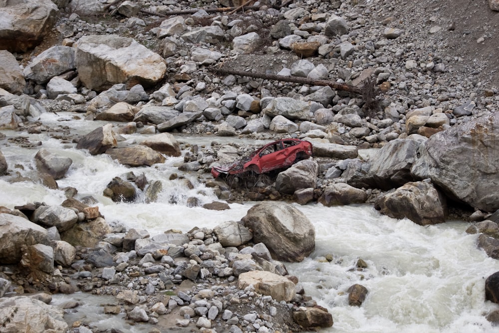 a red raft is in the middle of a river