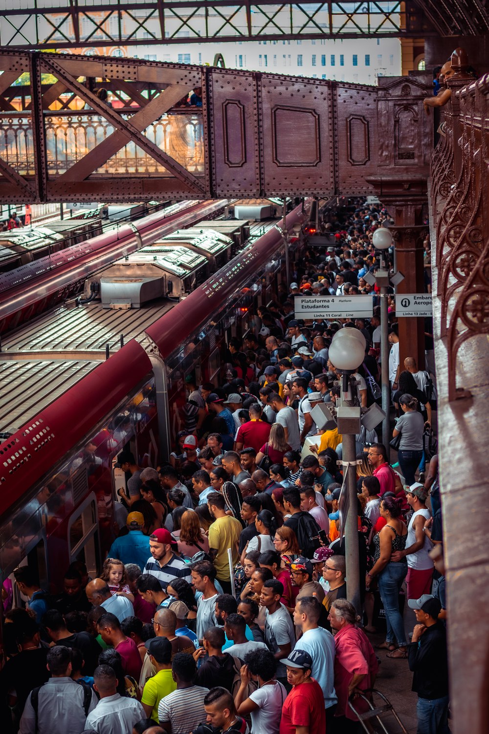 a crowd of people standing next to a train at a train station