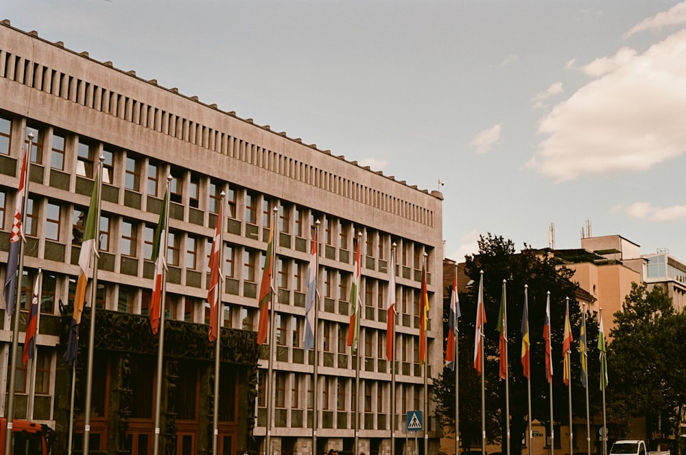 a large building with many flags in front of it