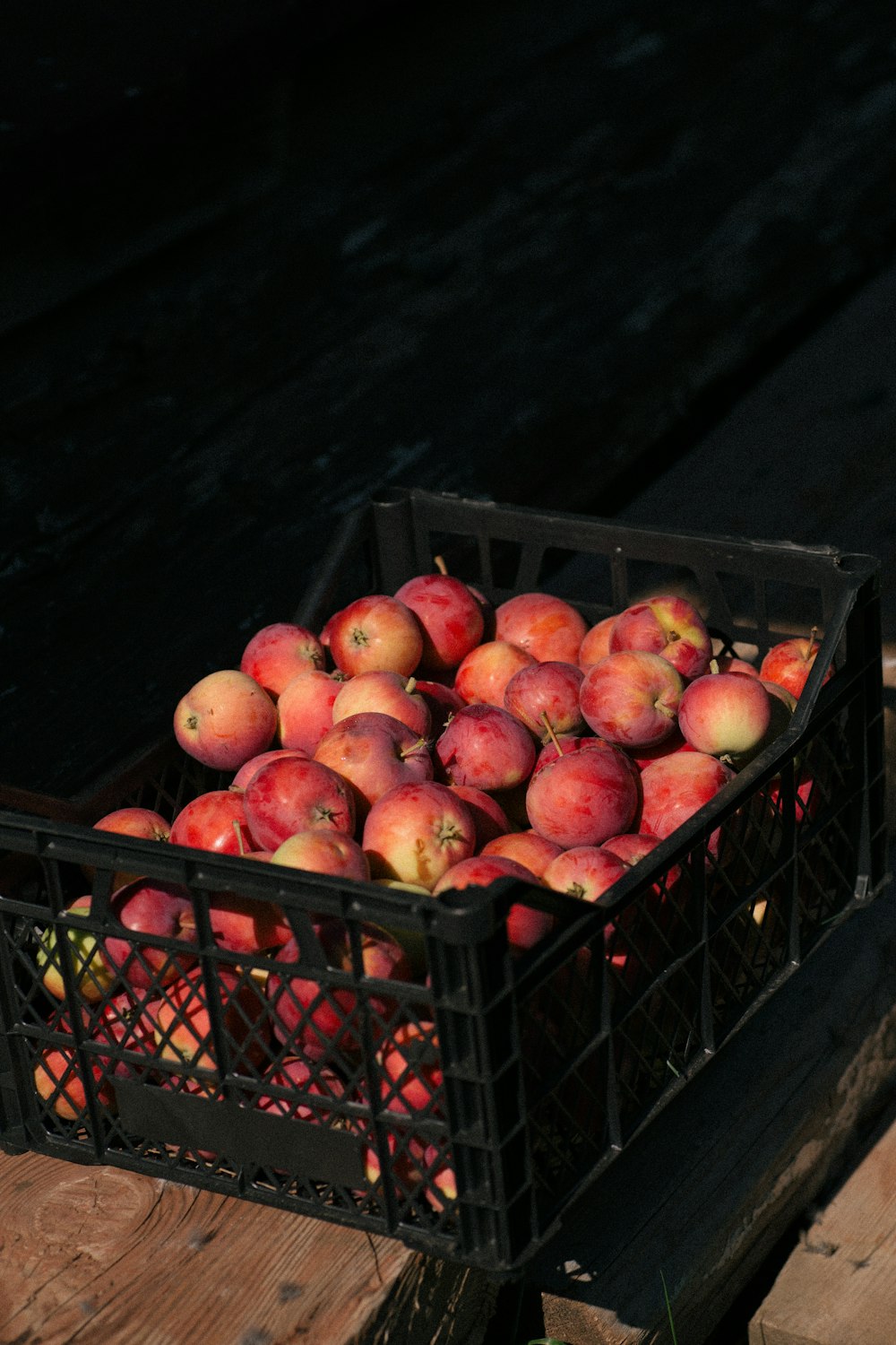 a crate filled with lots of red apples
