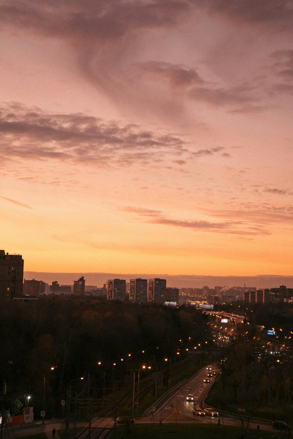 a view of a city from a hill at sunset