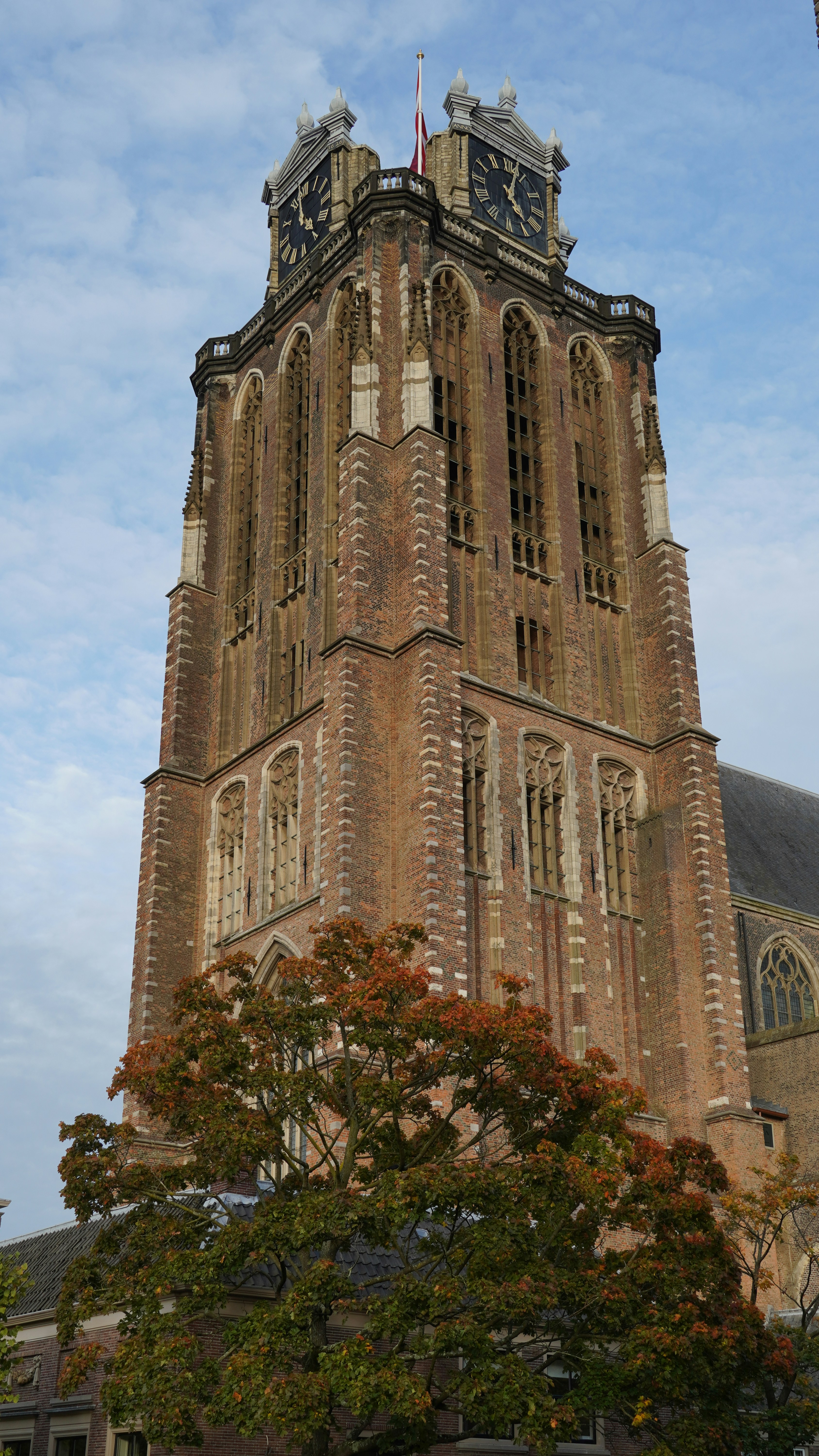 a tall brick building with a clock on the top of it