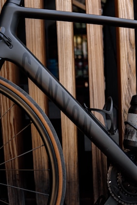 a close up of a bike parked next to a wooden fence