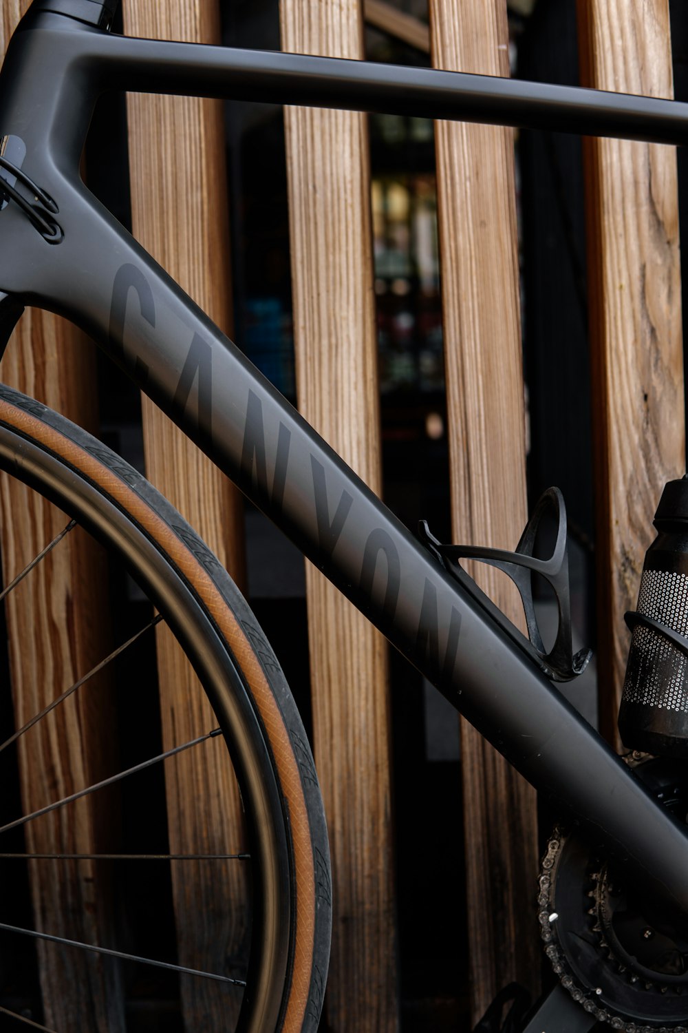 a close up of a bike parked next to a wooden fence