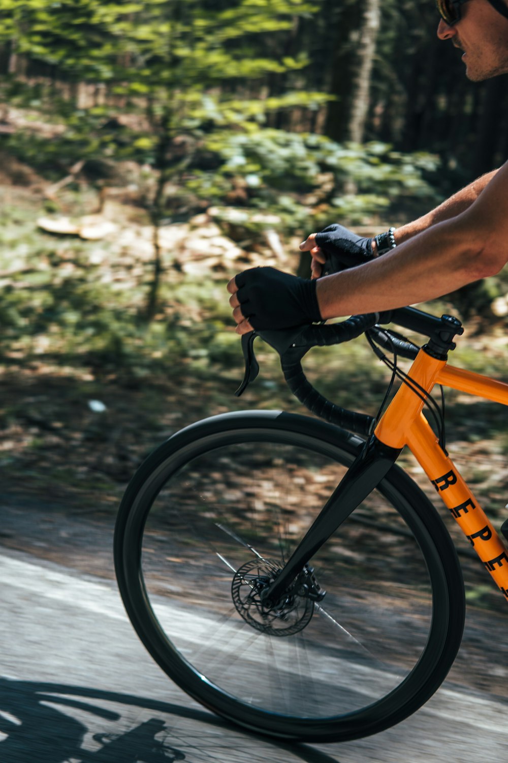 a man riding a bike down a road