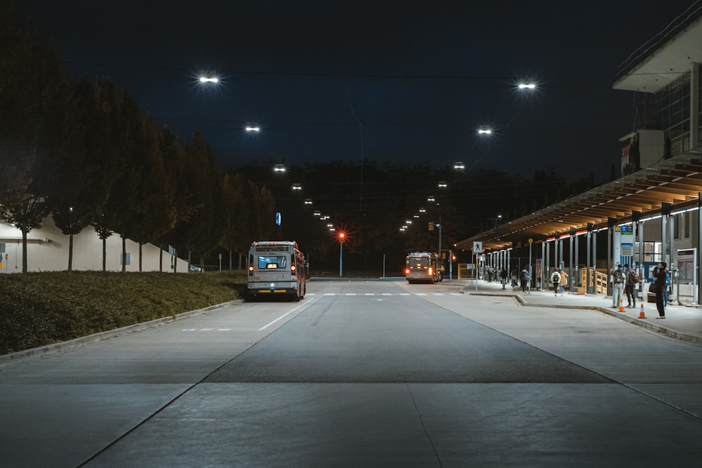 a bus parked at a bus stop at night