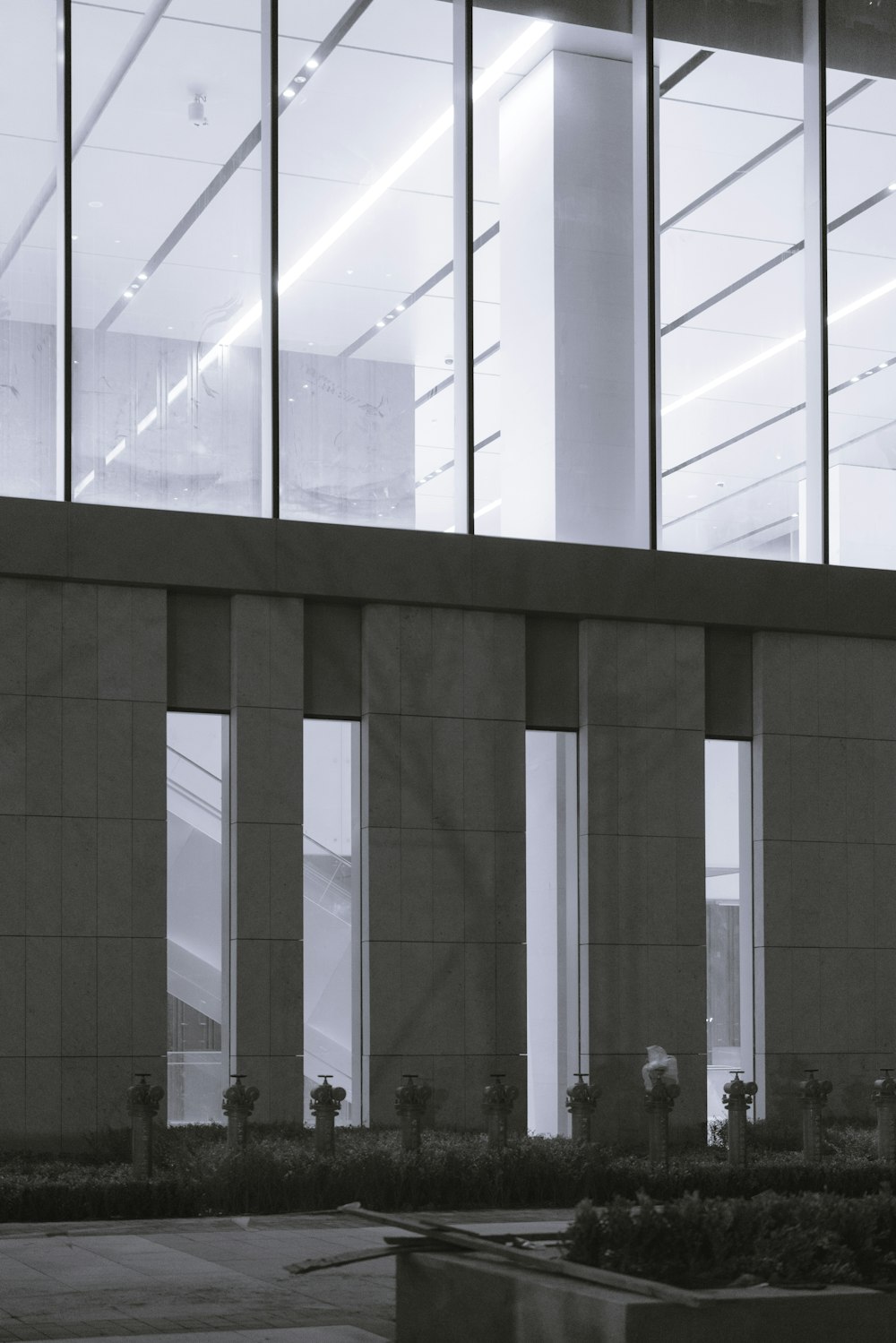 a black and white photo of a building with large windows