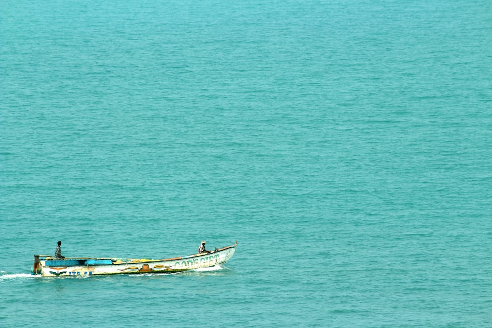 a small boat in the middle of a large body of water