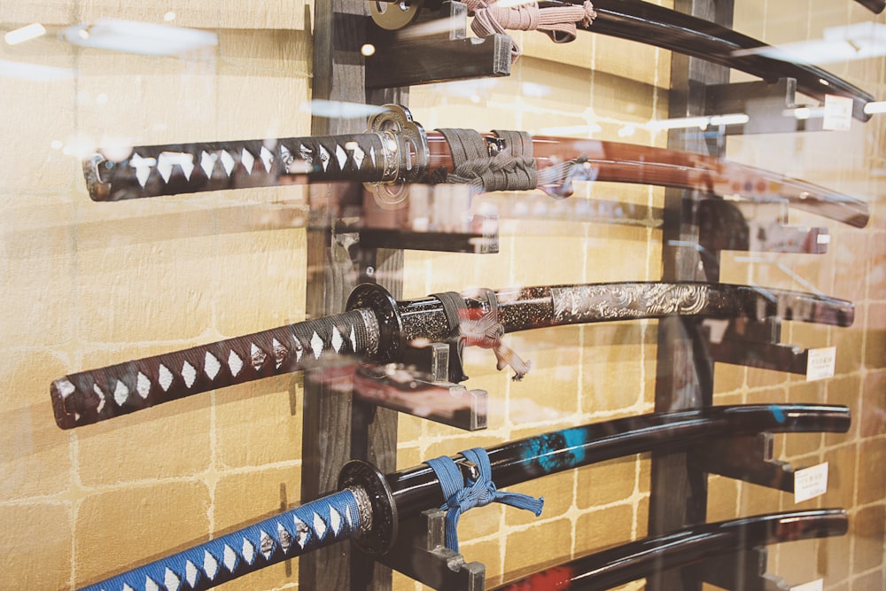 a display of different types of knives in a glass case