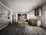A sleek modular kitchen with warm wooden cabinets and modern appliances in a 3 BHK apartment.