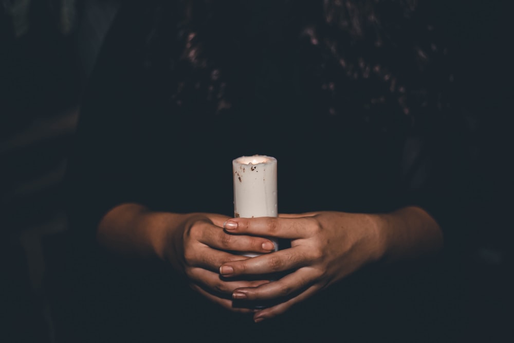 a person holding a candle in their hands