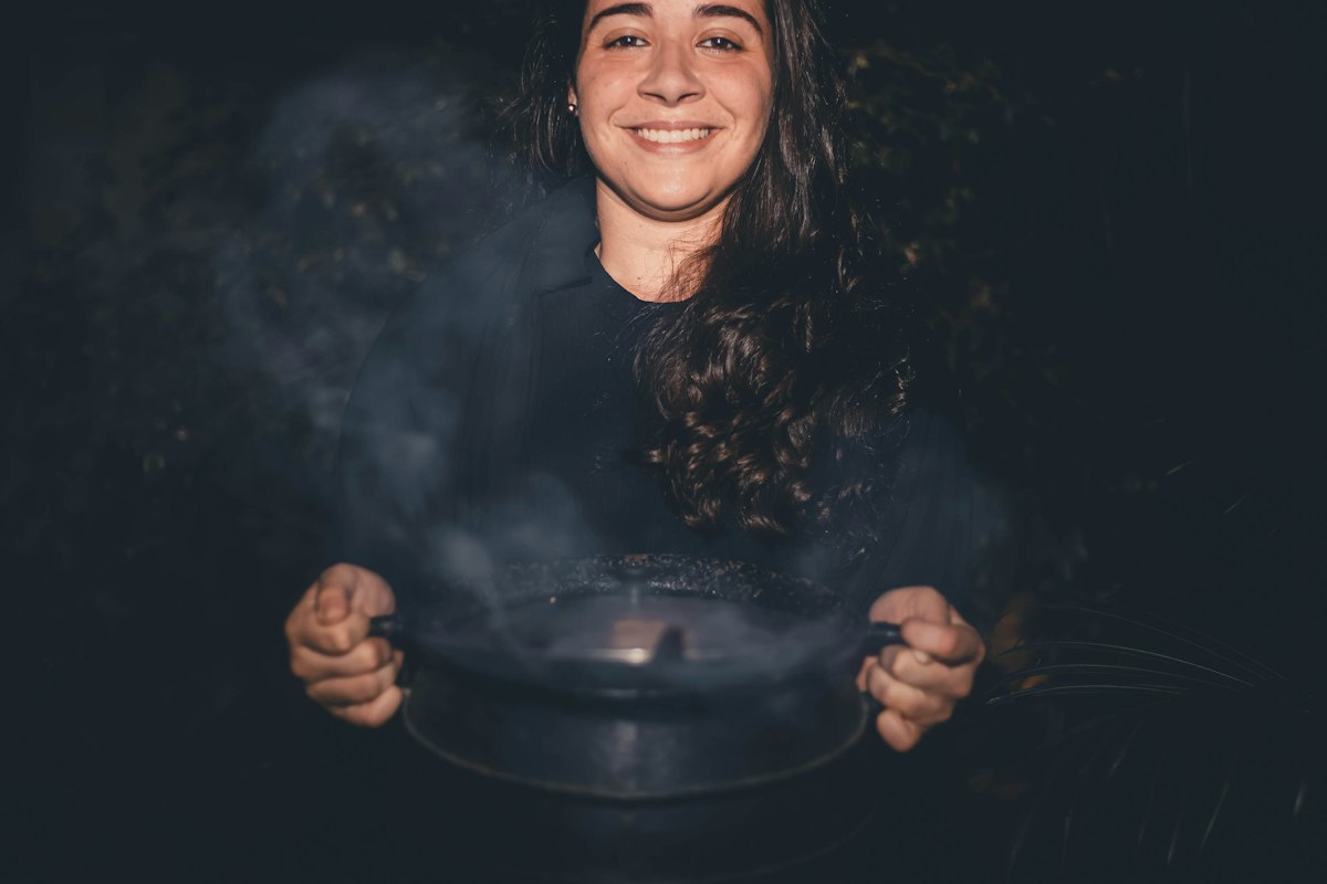 Person stirring a single portion meal in a small pot