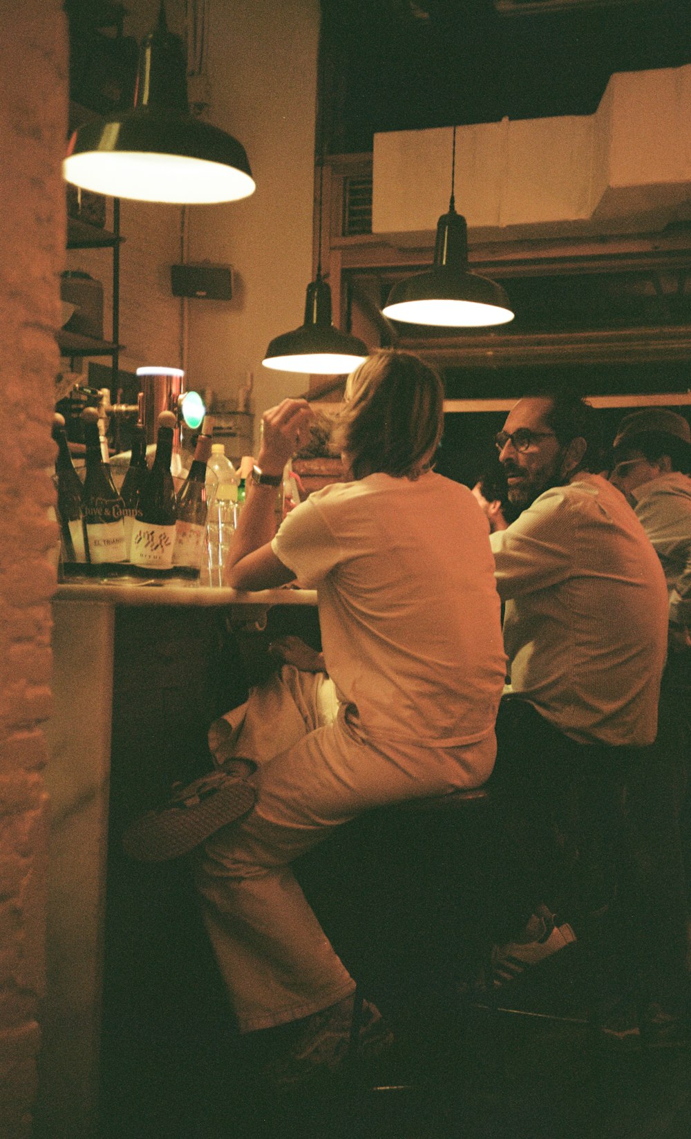 a group of people sitting at a bar