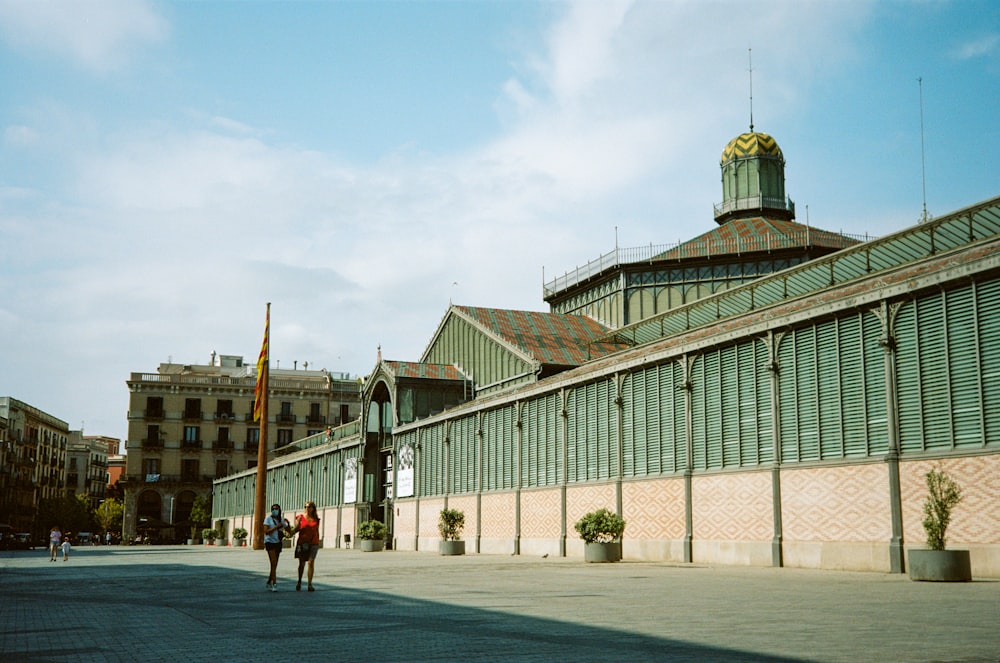 two people walking in front of a building