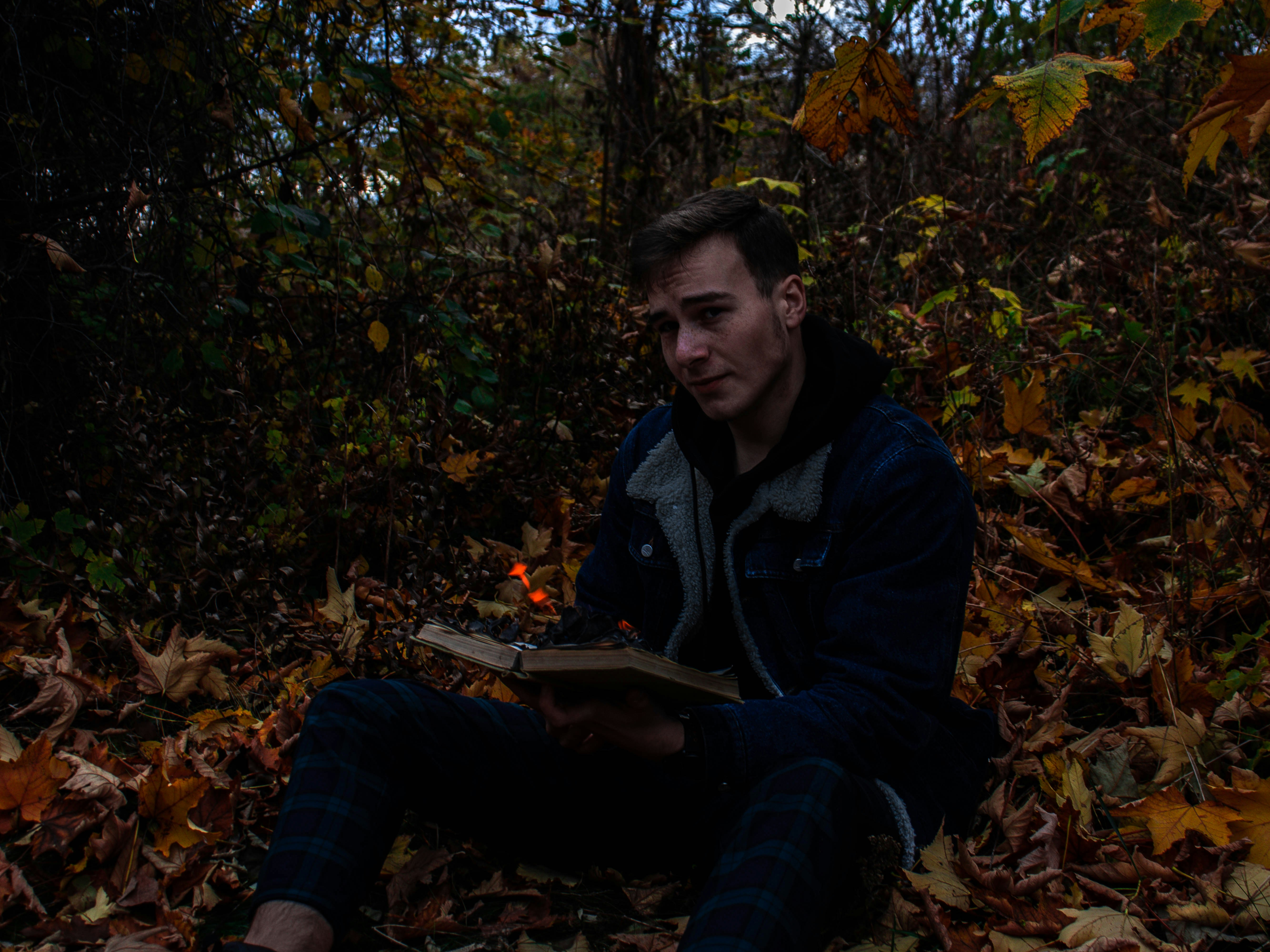 a man sitting on the ground reading a book