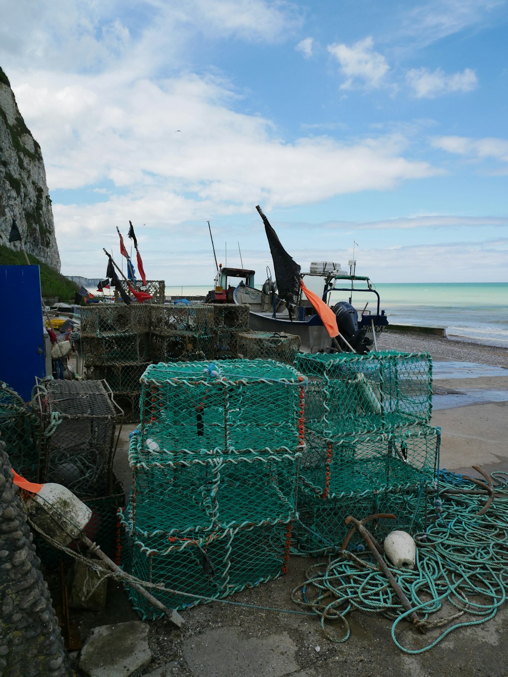 a pile of fishing nets sitting on top of a beach