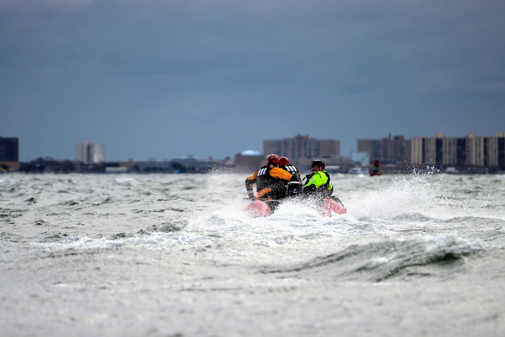 a couple of people riding on the back of a jet ski