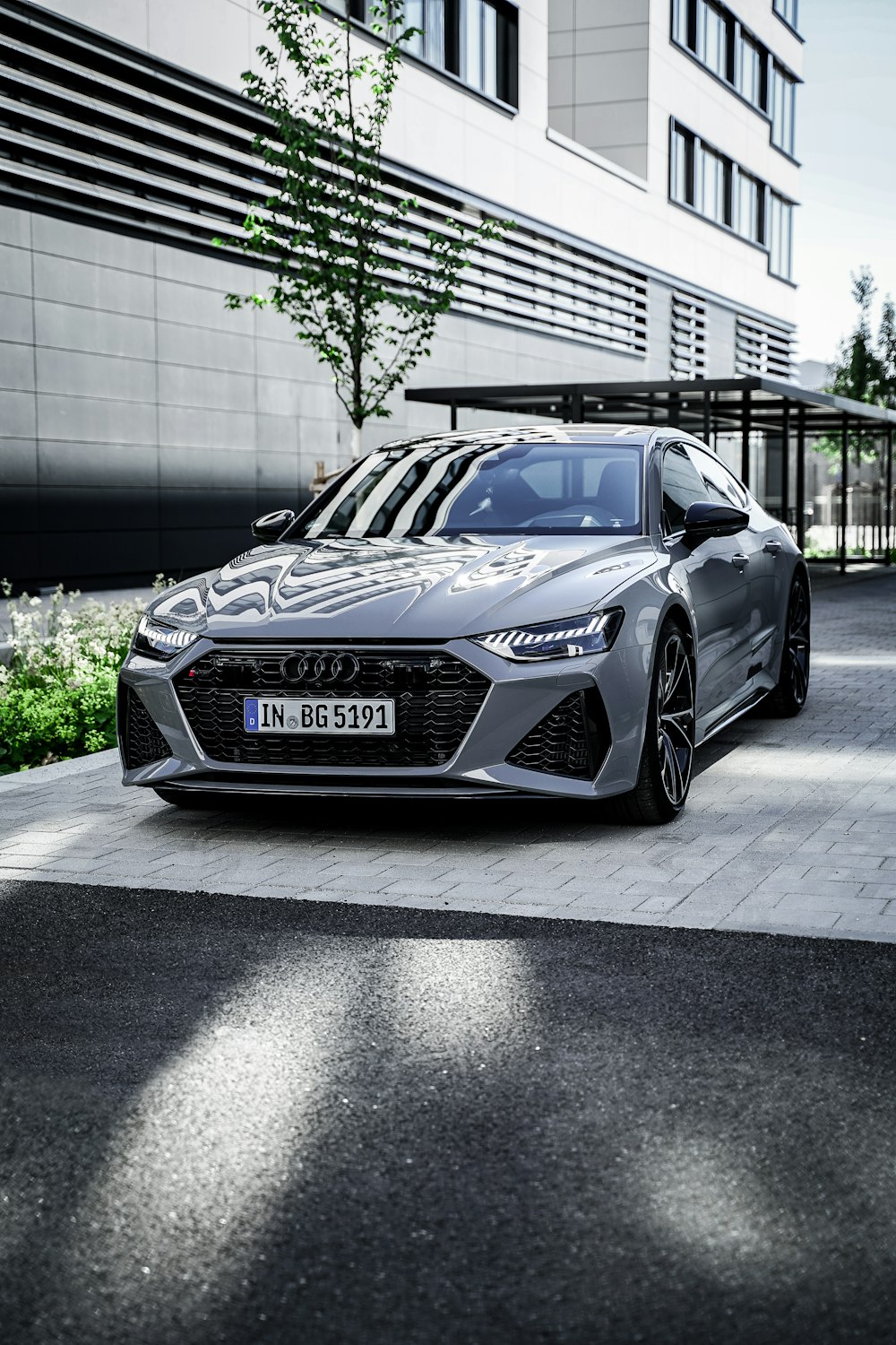 a silver car parked in front of a building