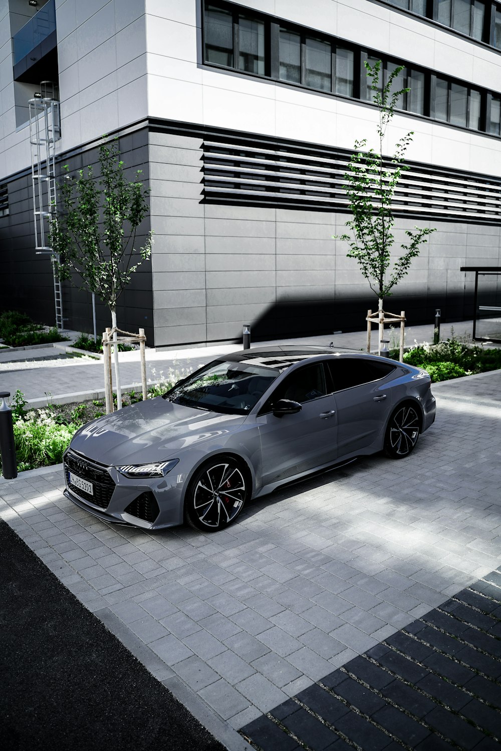 a silver car parked in front of a building