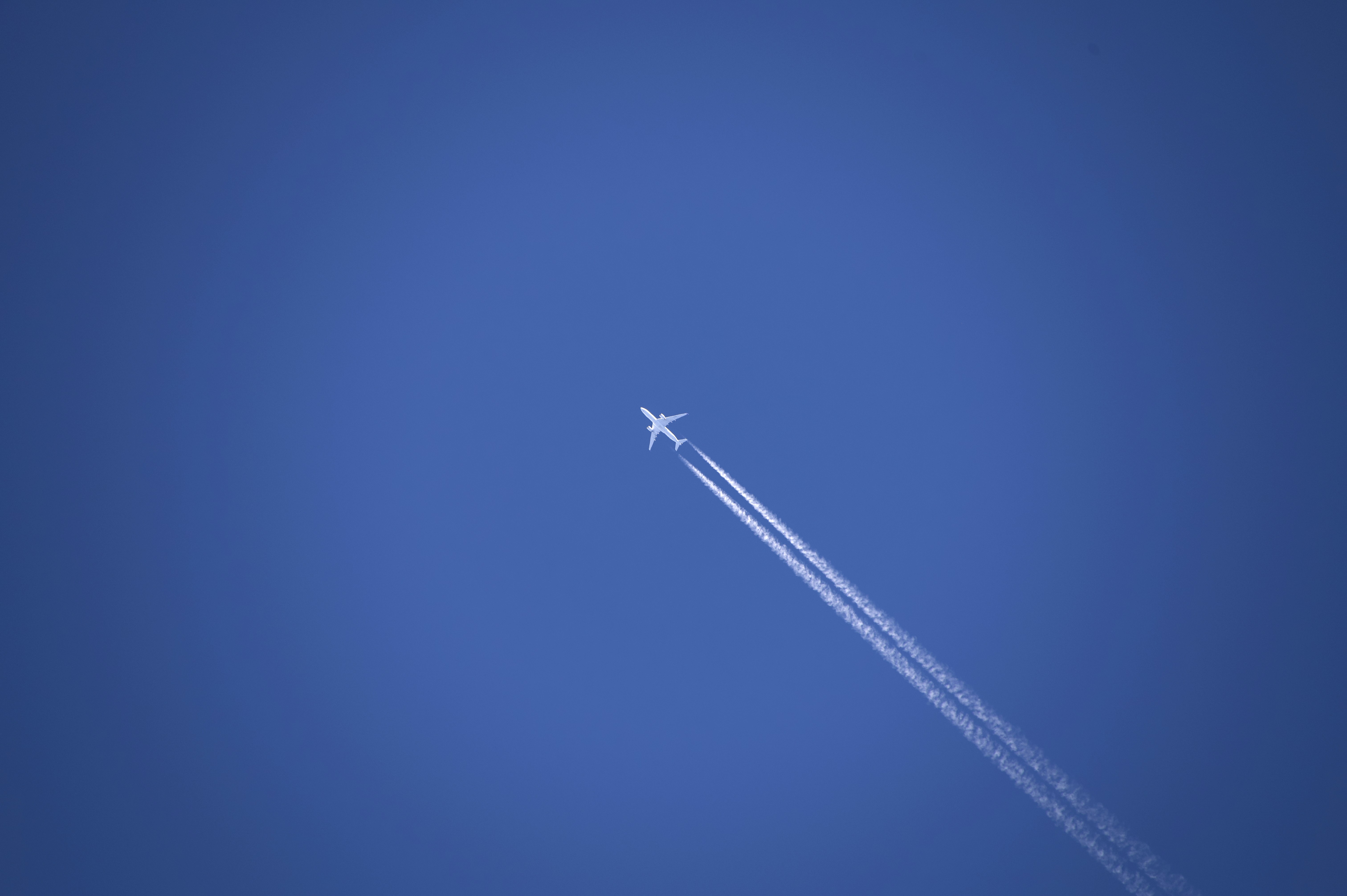 an airplane is flying high in the sky, 