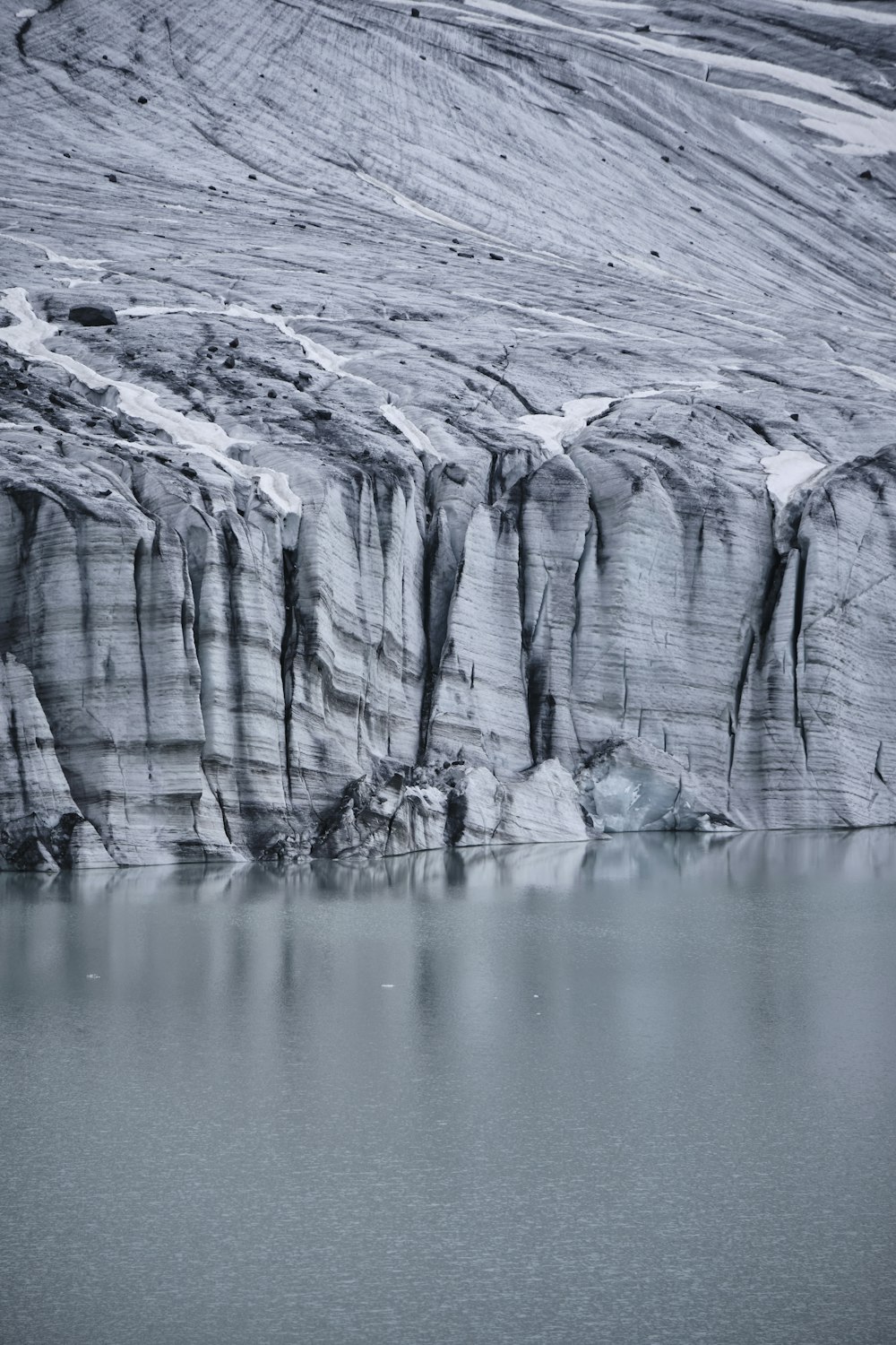 a large iceberg with a large body of water in front of it