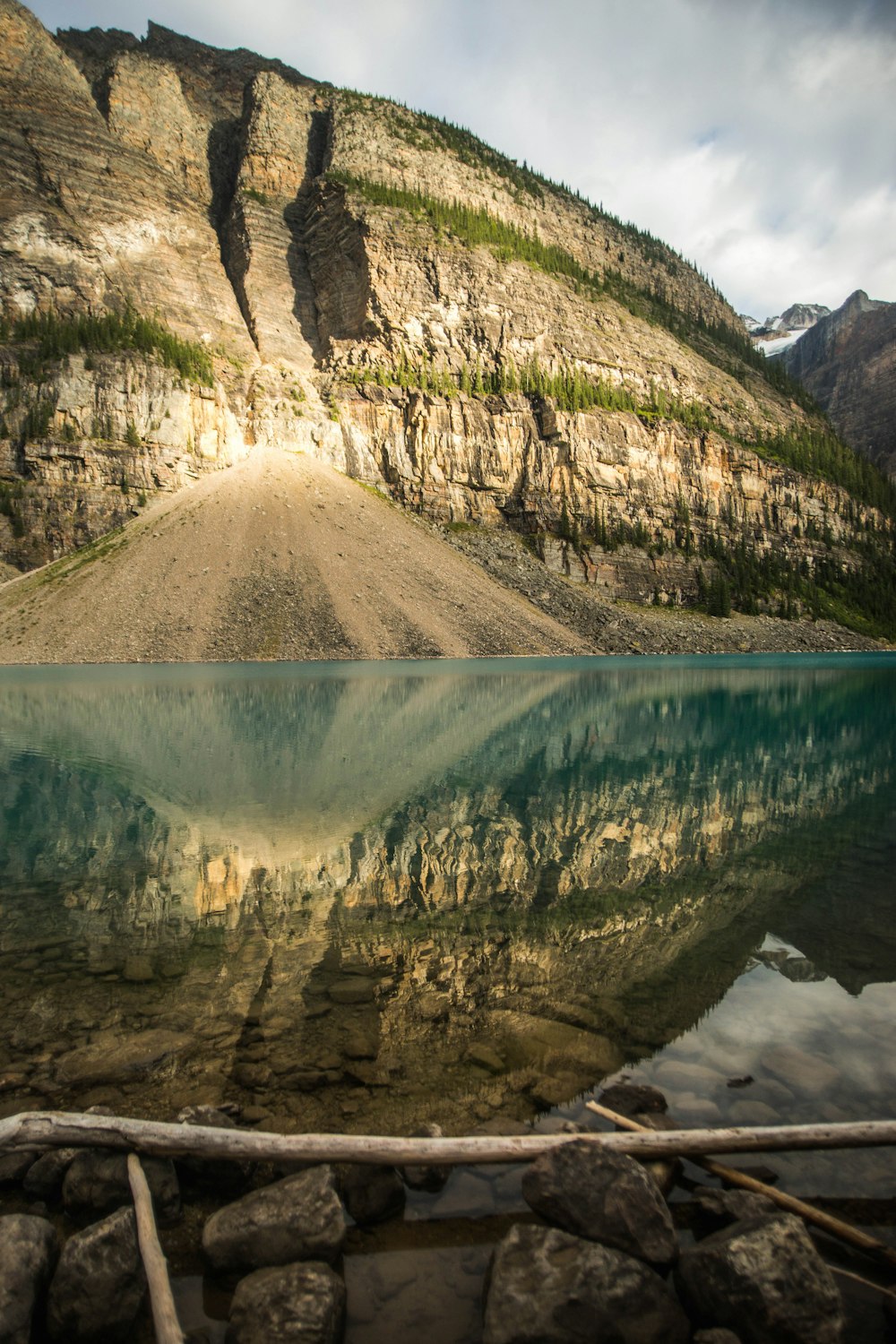 a mountain is reflected in the still water of a lake