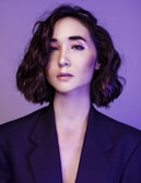 A large professional portrait of Lilifeltran with a soft pink background.