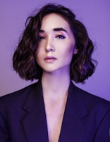 Casual yet polished portrait of a team member against a clean, bright background.