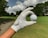 a person holding a golf ball in their hand
