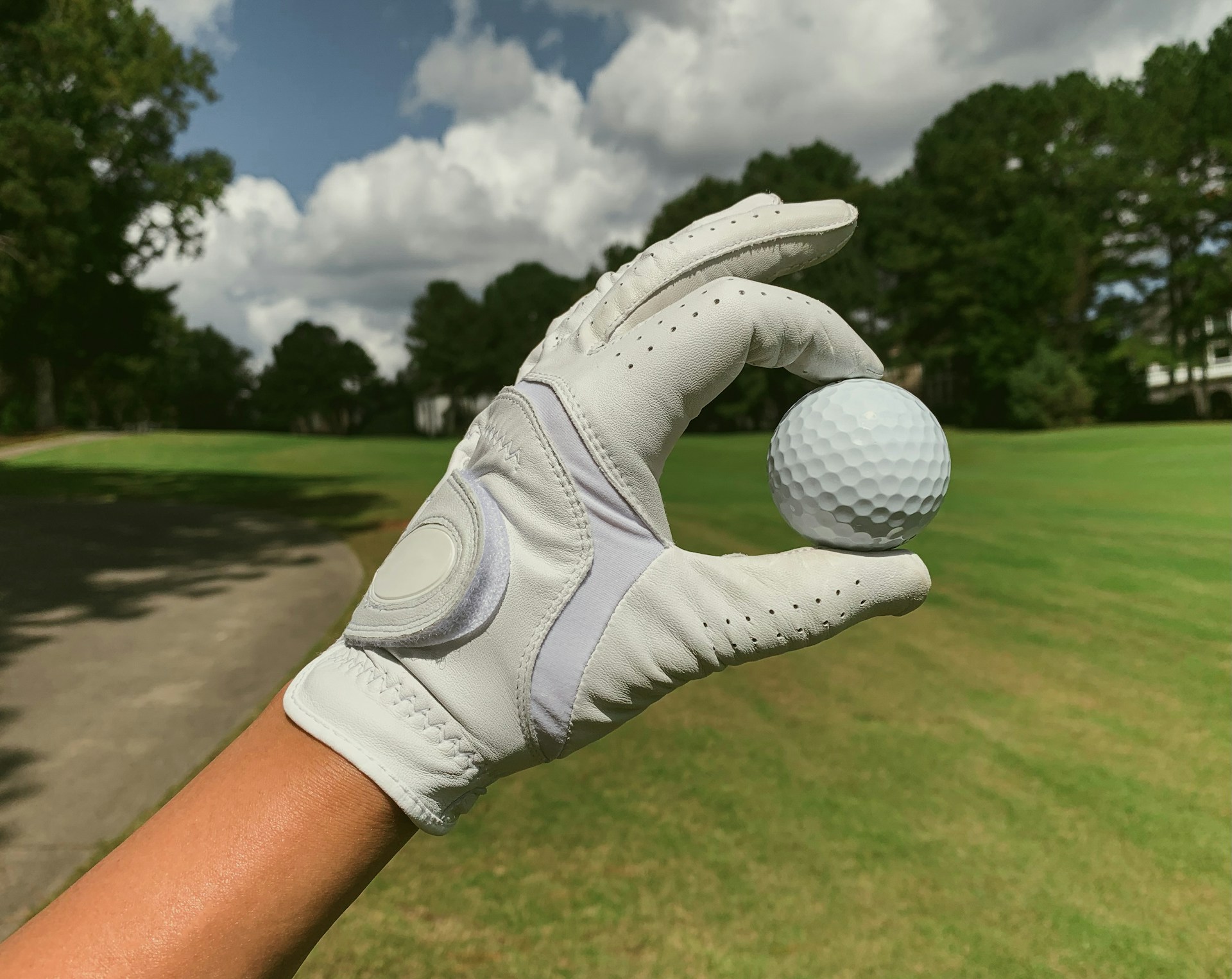 a person holding a golf ball in their hand