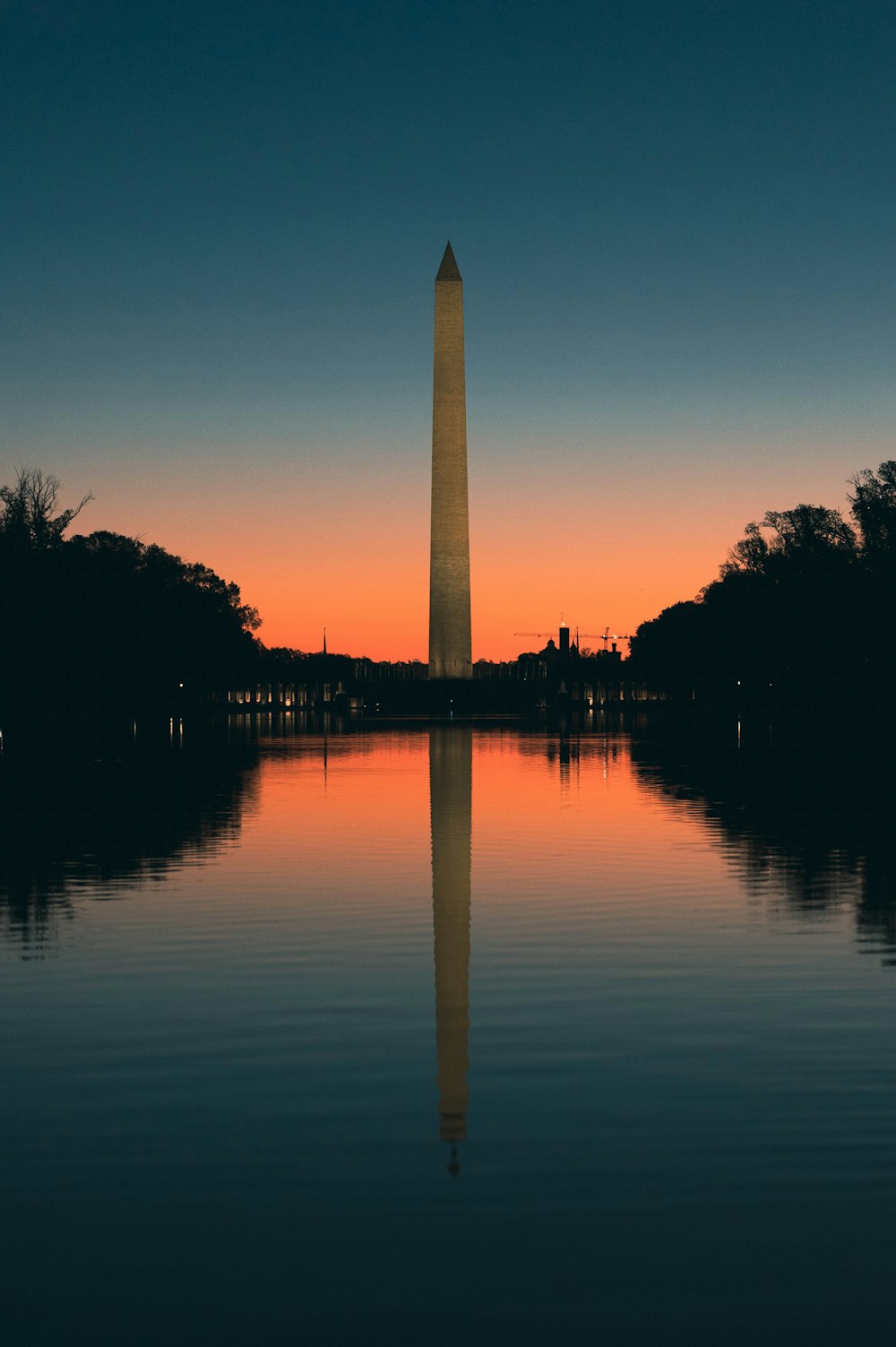 the washington monument is reflected in the water