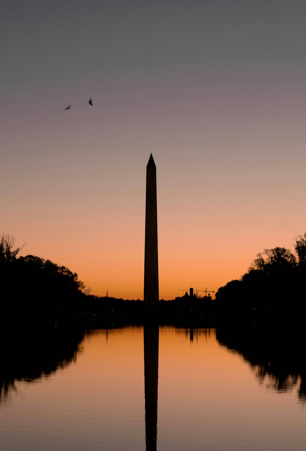 a tall obelisk in the middle of a body of water