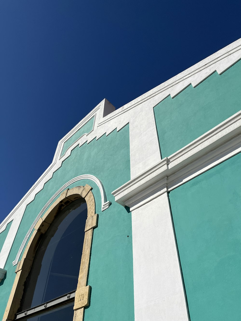 a blue and white building with arched windows