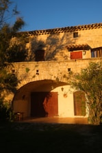 Rustic stone wall on a charming house bathed in soft sunlight.
