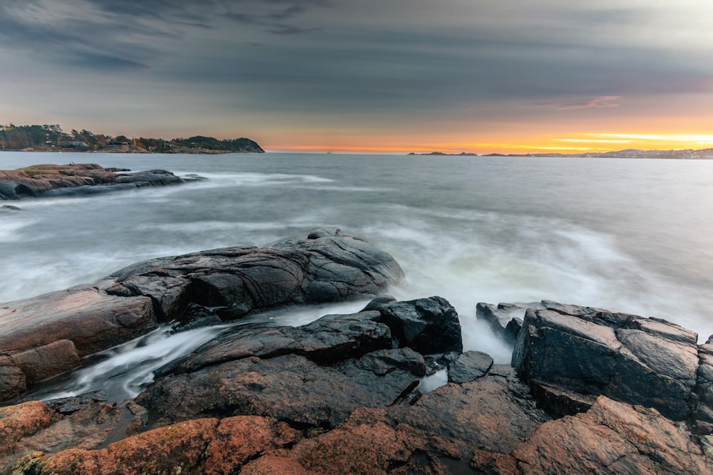 a rocky beach with waves coming in and out of the water