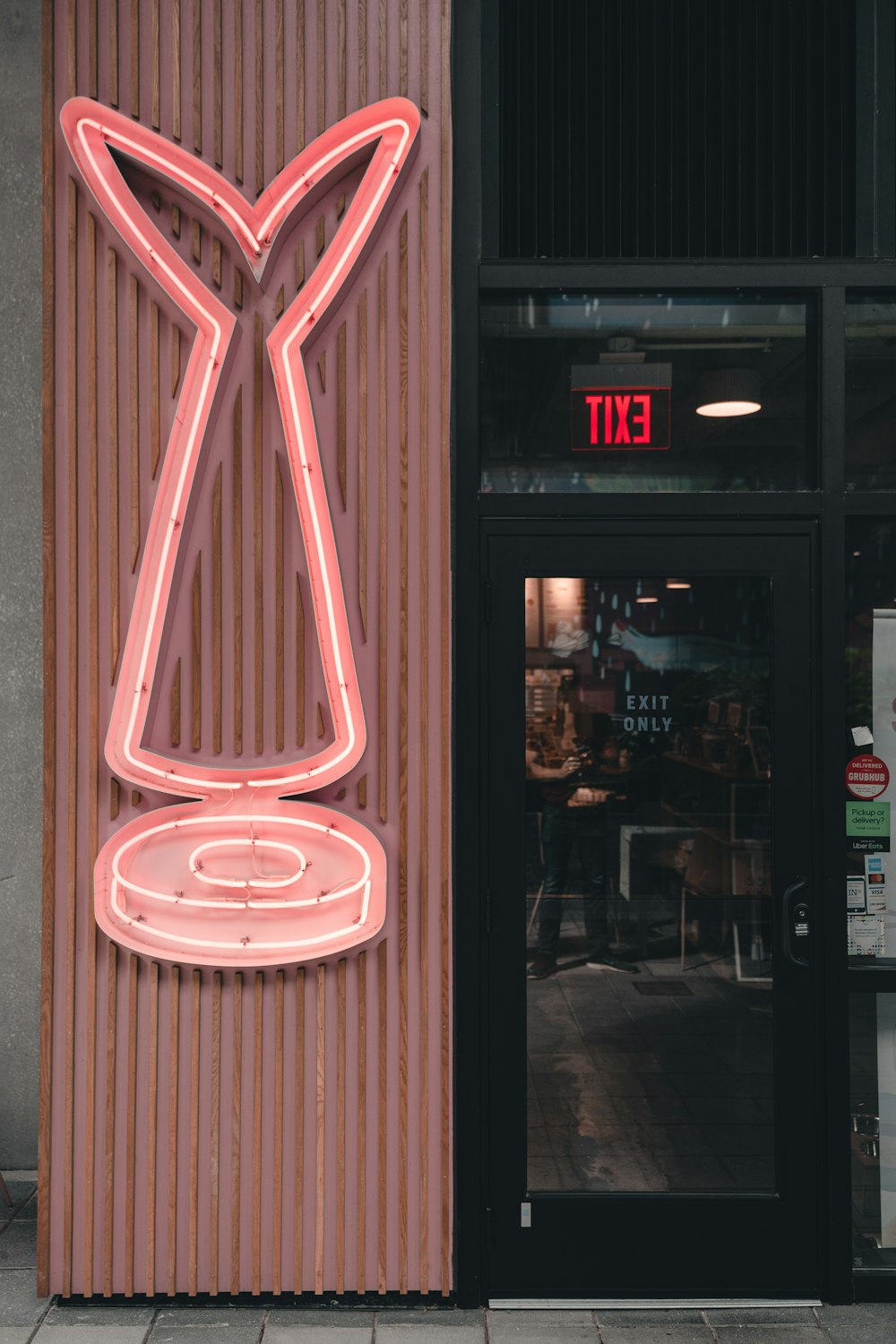 a neon sign on the side of a building