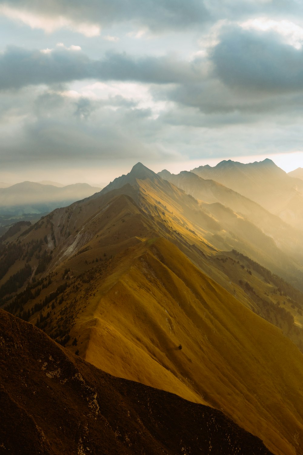 a view of a mountain range with a cloudy sky